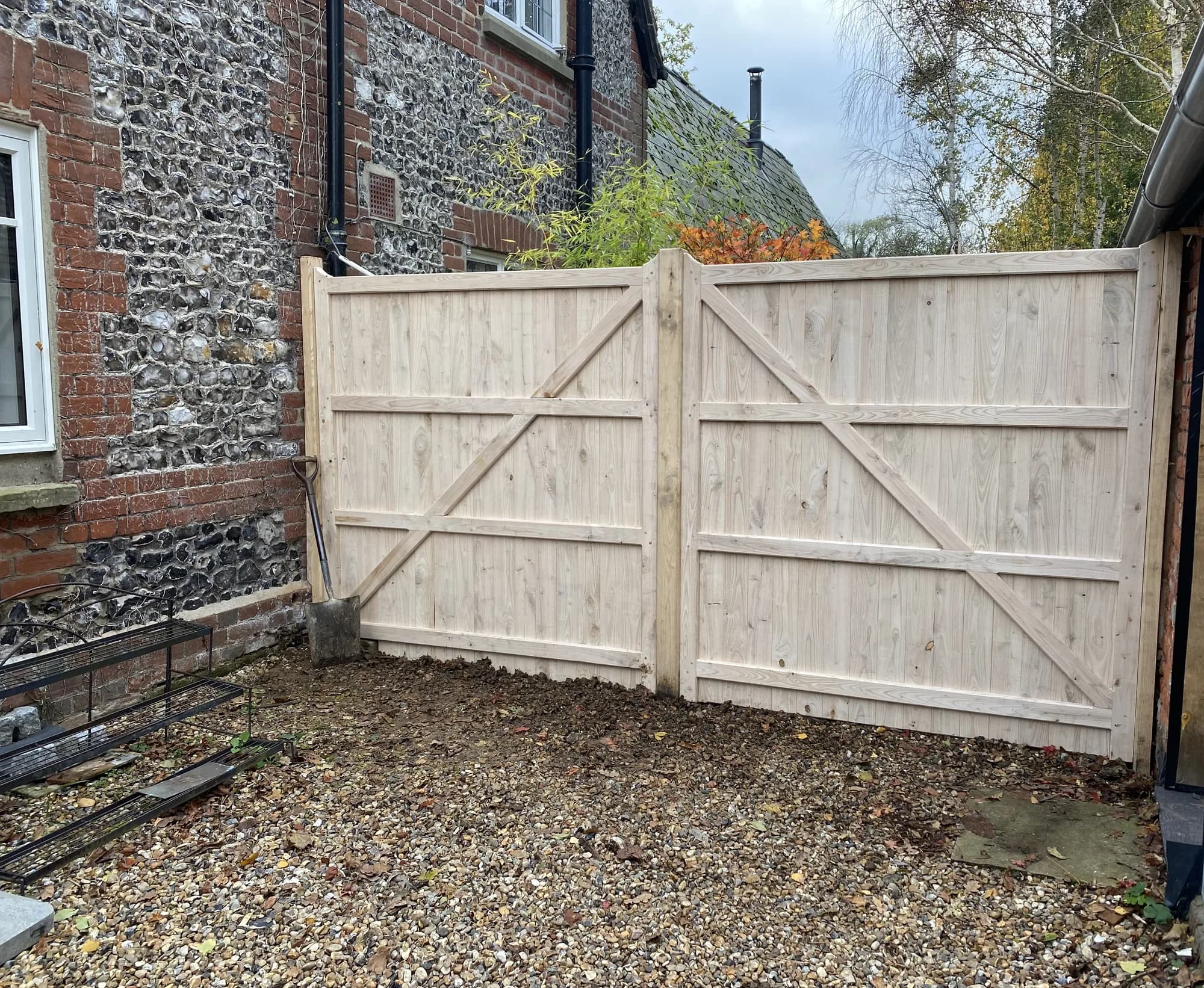 boarded gates on gravel drive