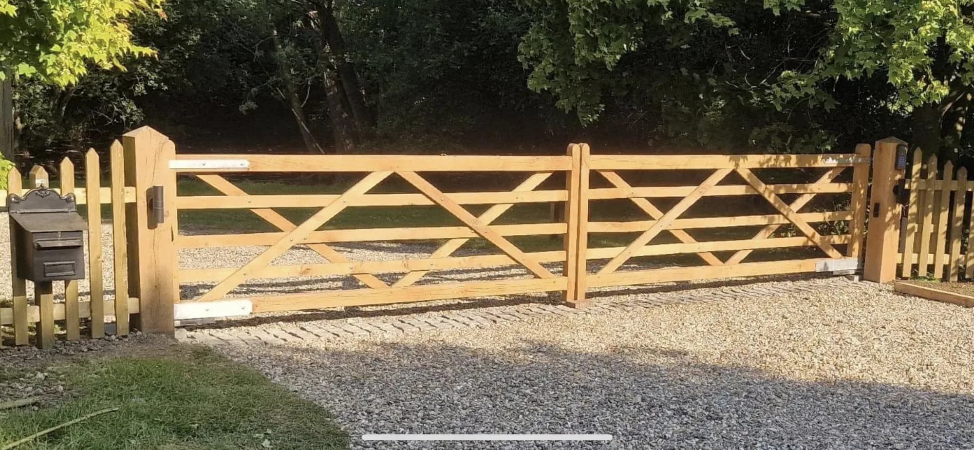 five-bar gate gravel drive picket fence