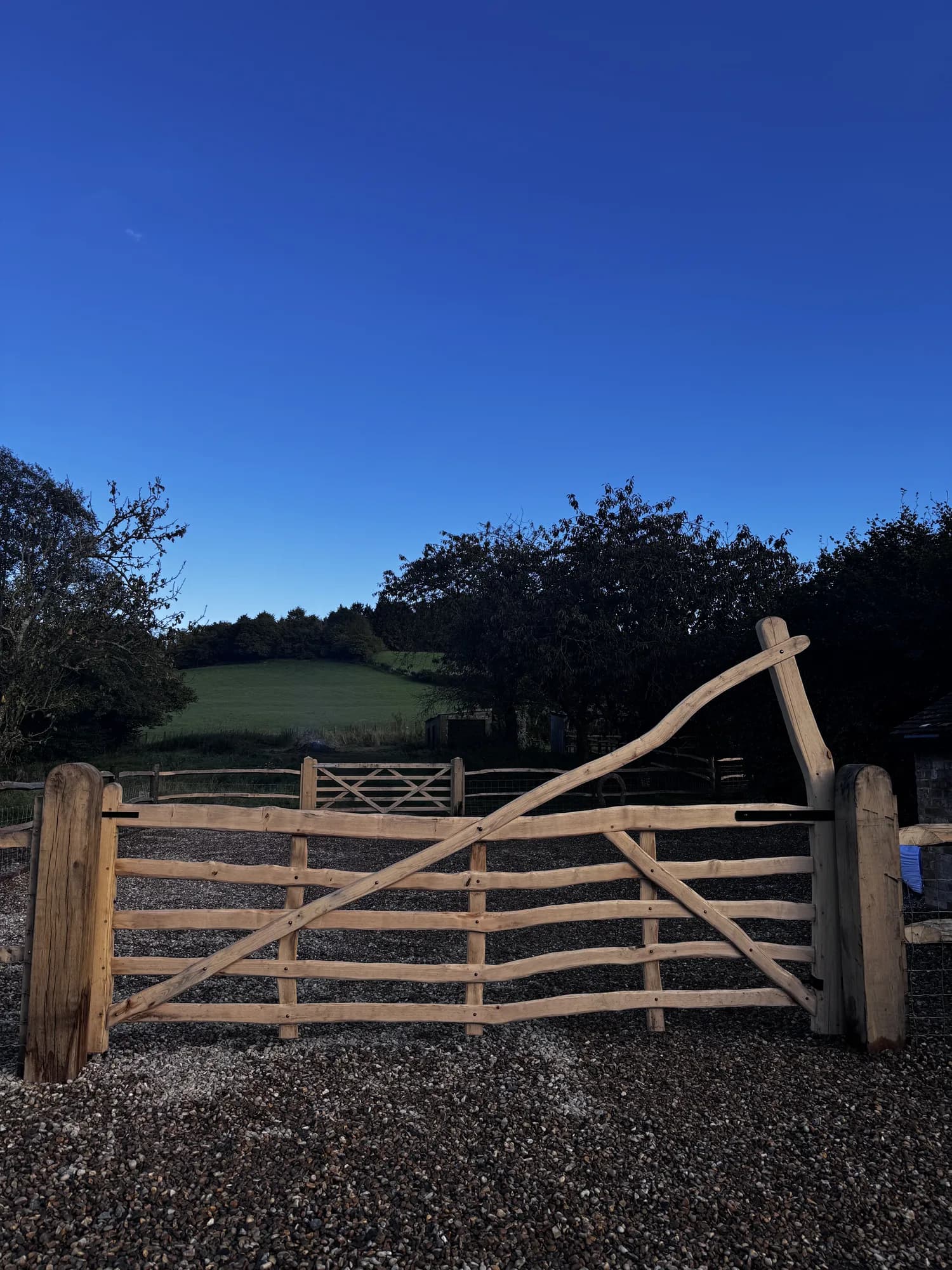 curved rising five-bar gate blue sky
