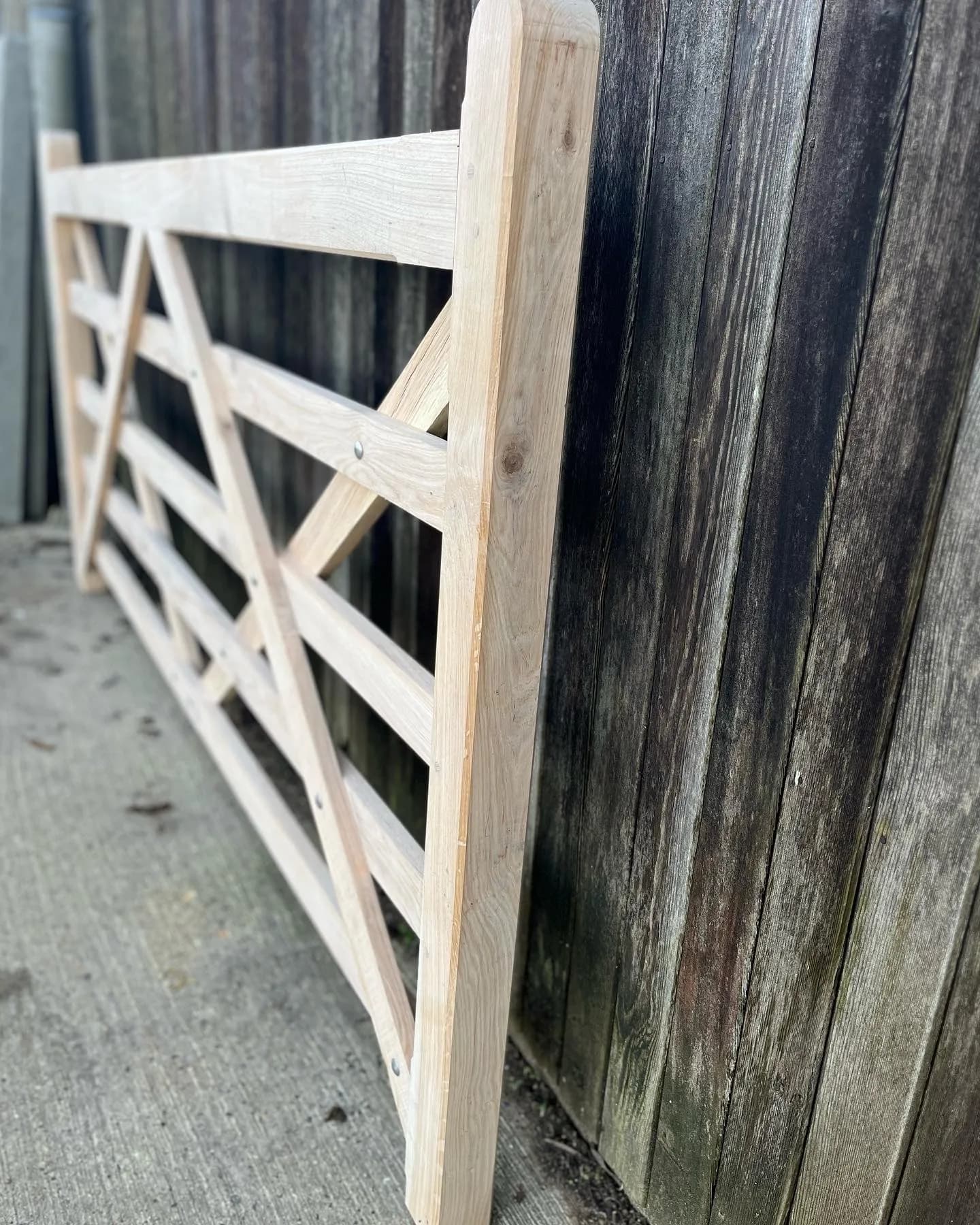 wooden field gate against barn boards