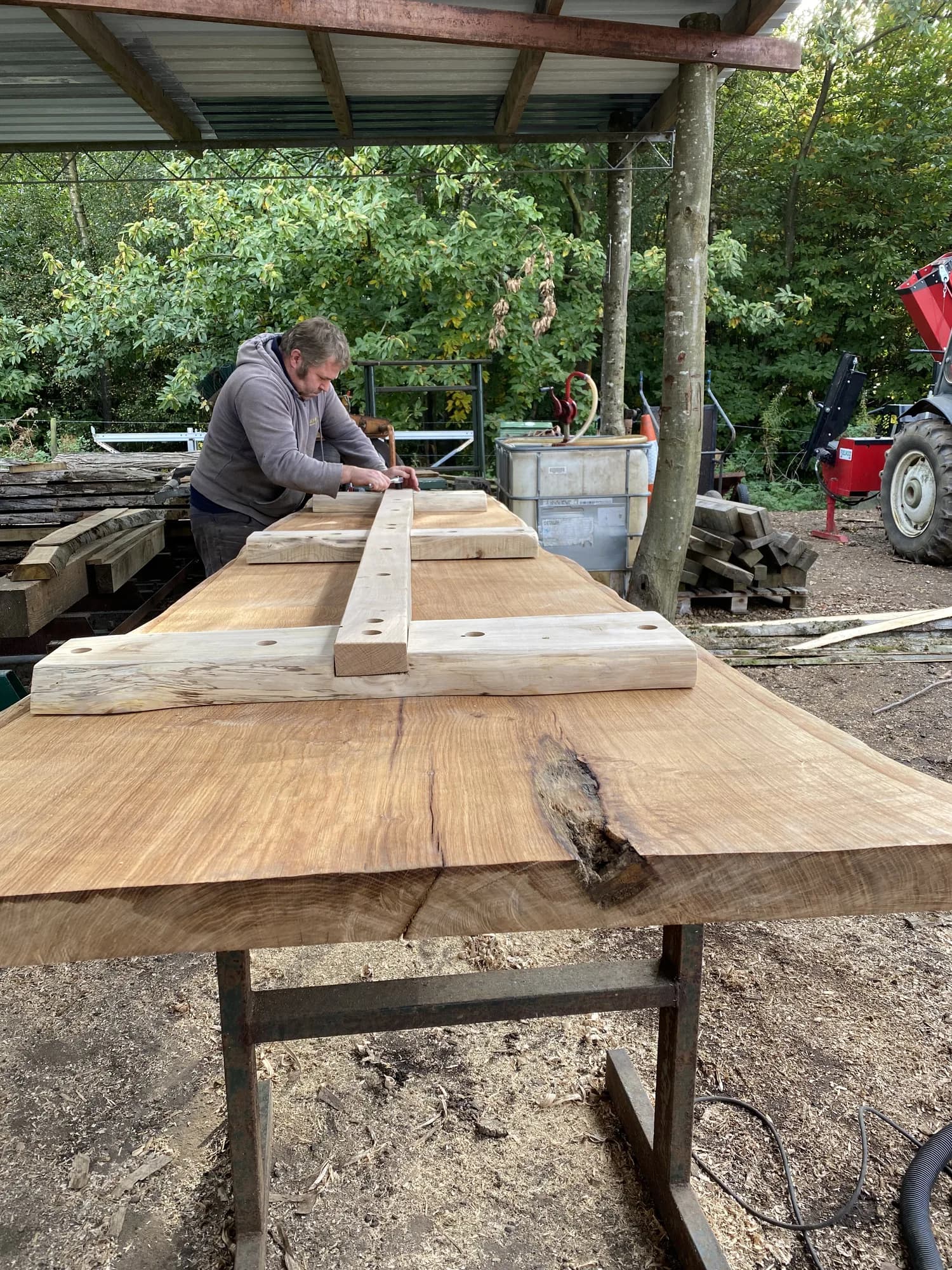 man fitting long bench joinery
