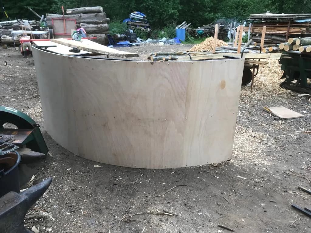 large curved plywood bar shell outdoors